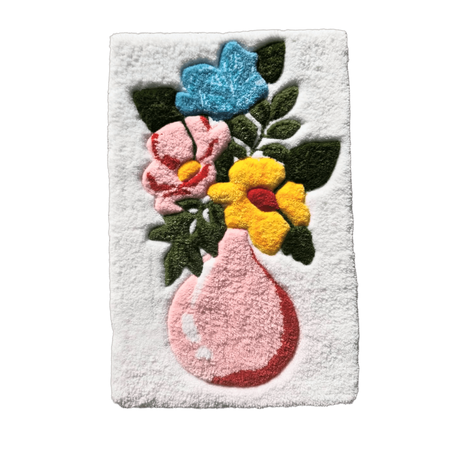 A hand-tufted floral arrangement that never wilts. Blue, pink, and yellow blooms with layered green leaves rise from a soft pink vase on a clean white base — a piece of everyday color that lasts far longer than fresh-cut flowers.
